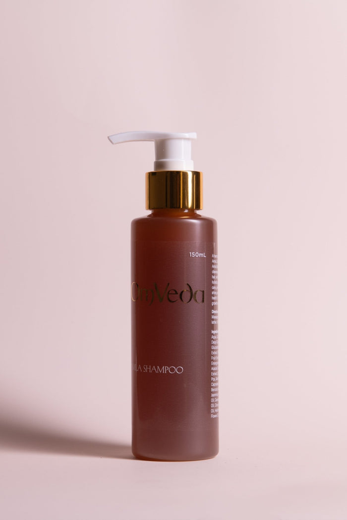 OmVeda amla shampoo bottle with white pump, brown plastic bottle