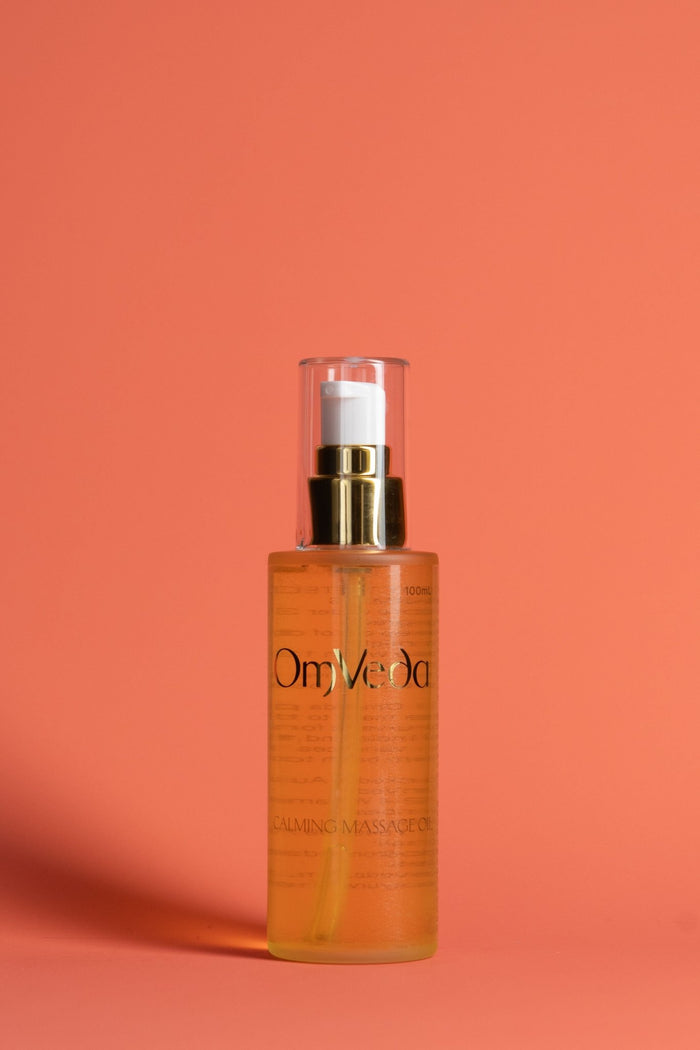 Calming massage oil bottle with gold pump, amber glass, OmVeda Professional