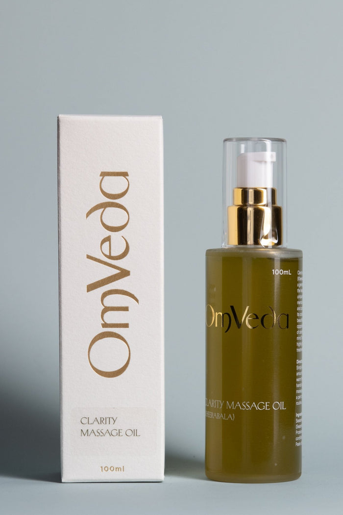 OmVeda body oil with box, clear pump glass bottle and gold label