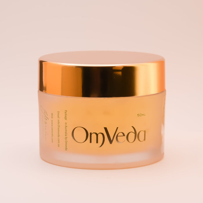 OmVeda Golden Glow treatment gel jar with peach body and gold lid