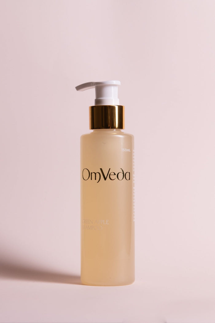 OmVeda Green Apple shampoo bottle with white pump, amber-gold liquid, 150 ml