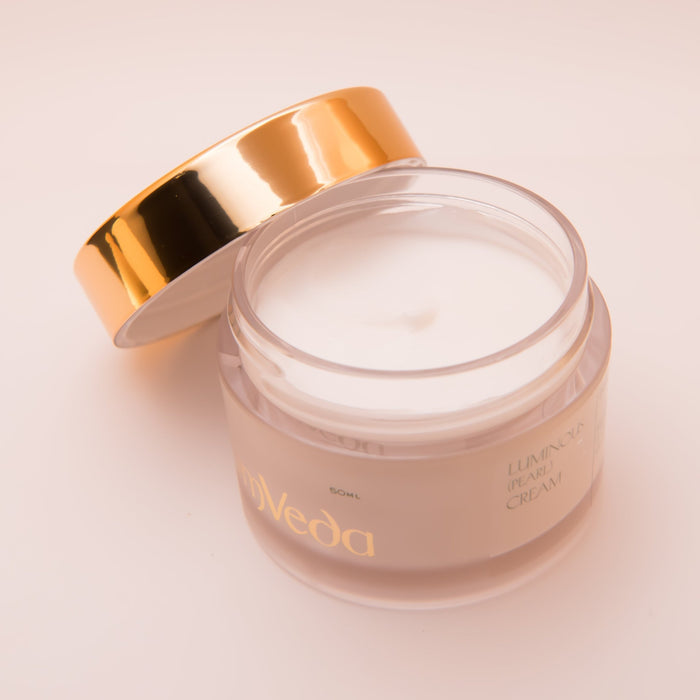 Open luminous moisturiser jar with gold lid and pearl cream inside; 50 ml