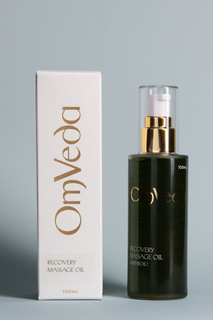 Recovery massage oil bottle with gold pump and matching box, dark green glass