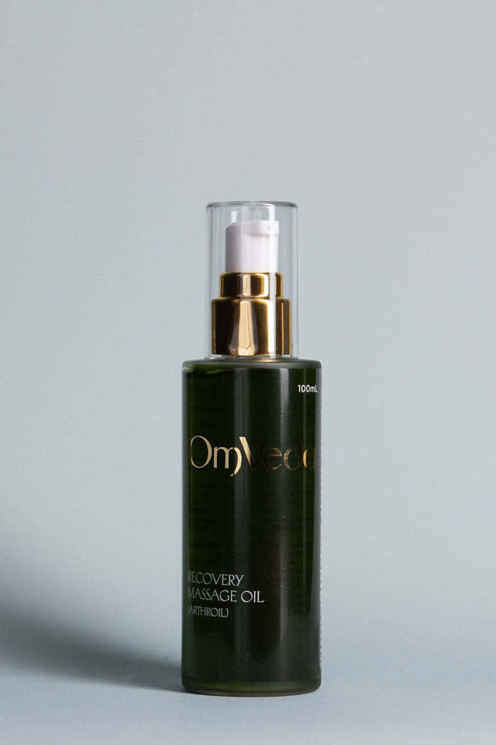 Recovery massage oil bottle with clear pump and gold dispenser, dark green glass