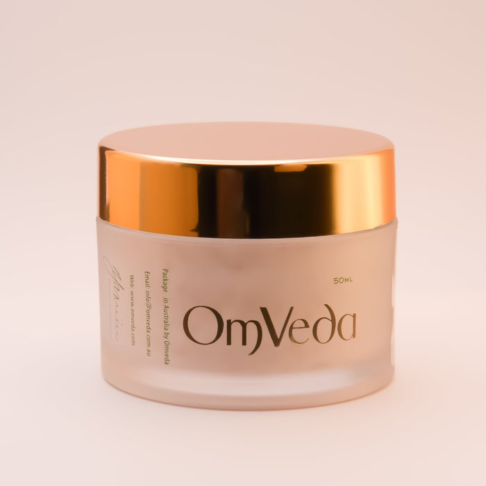 OmVeda walnut facial scrub jar with gold lid, cream-colored jar