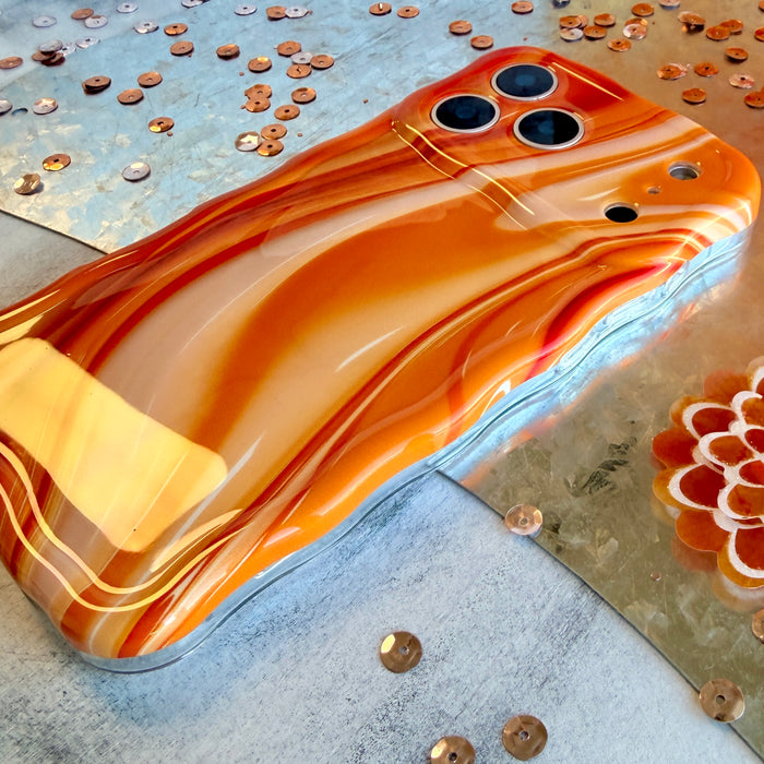 Orange Crush MagSafe iPhone case with swirled marble pattern in sunset orange by Fancy Bands
