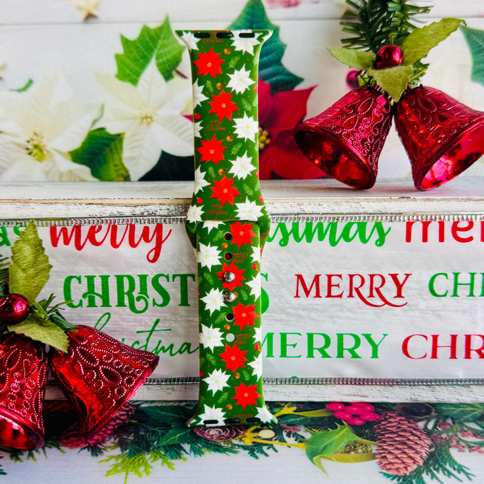 Close-up of Poinsettia Pines print showing vibrant red flowers, white blooms, and lush green pine on Apple Watch silicone band