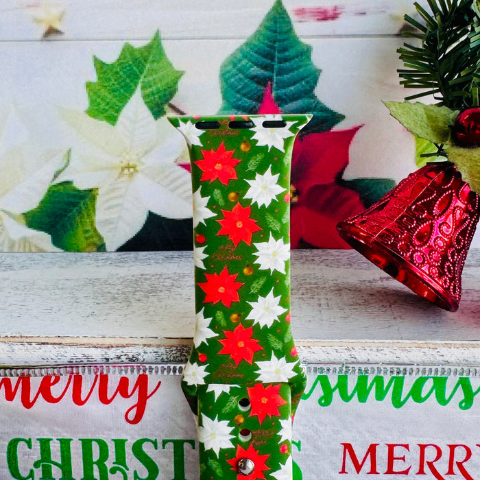 Close-up of Poinsettia Pines print showing vibrant red flowers, white blooms, and lush green pine on Apple Watch silicone band