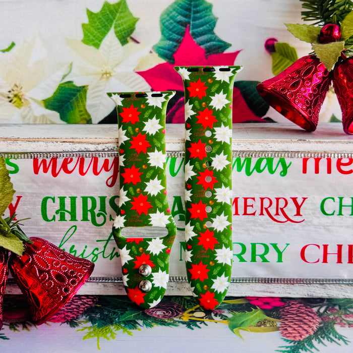 Close-up of Poinsettia Pines print showing vibrant red flowers, white blooms, and lush green pine on Apple Watch silicone band