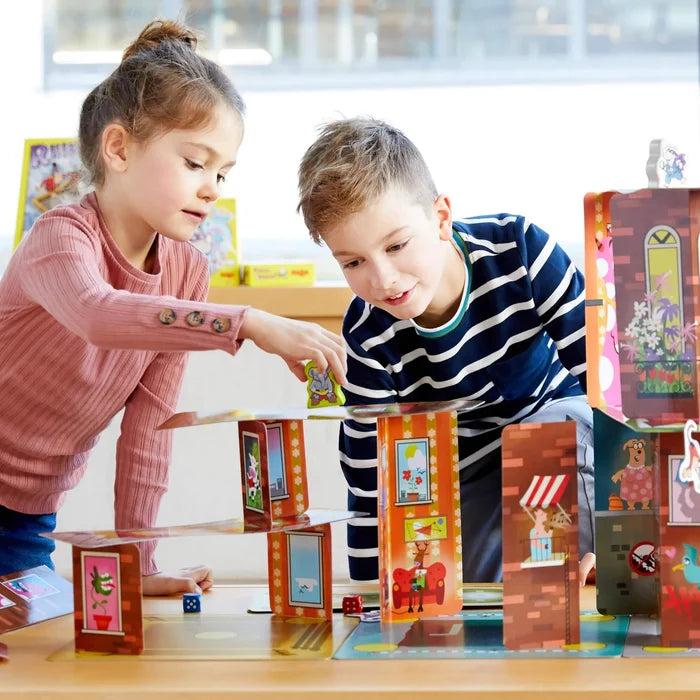 Two children playing Rhino Hero Super Battle on a table