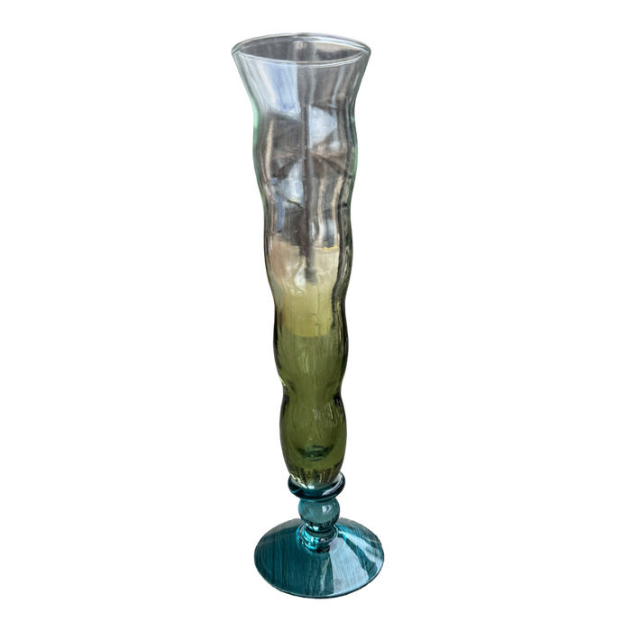 Tall glass vase with ribbed design on a white background