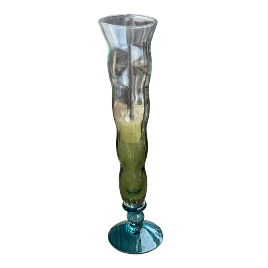 Tall glass vase with ribbed design on a white background