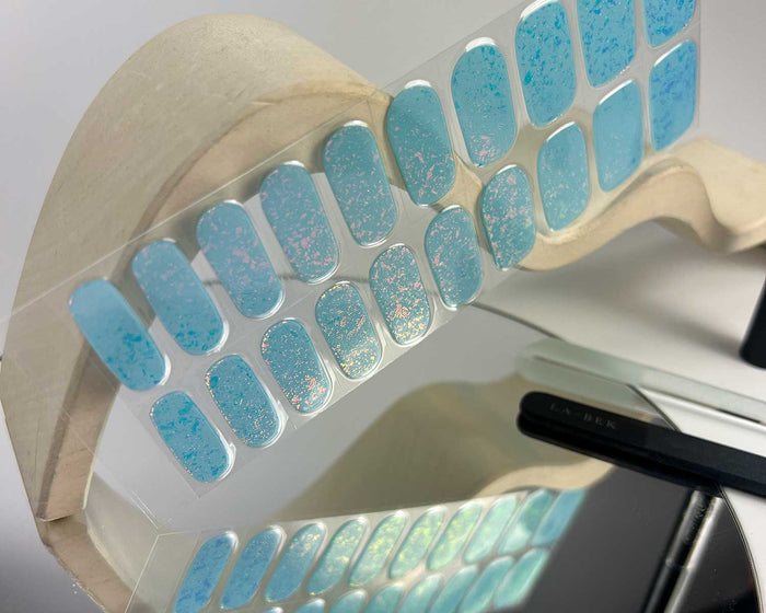 Frozen Speckle semi-cured gel nail wraps on a nail mock-up, alternate angle
