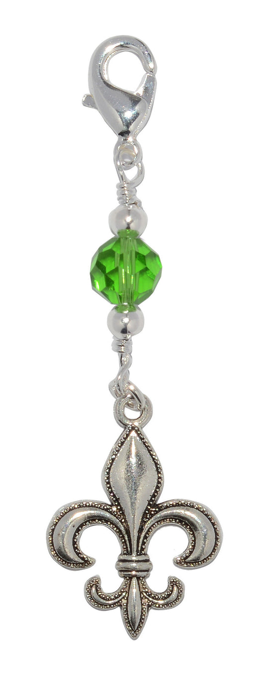 Silver fleur-de-lis charm large hair accessory with green glass bead on white background