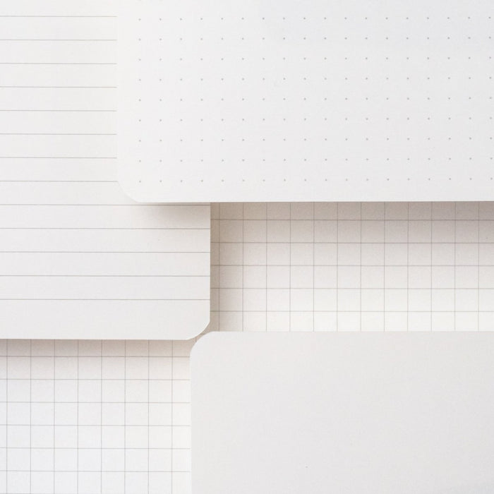 Blackwing Slate Notebooks displaying paper types: dot-grid, ruled, grid, and blank
