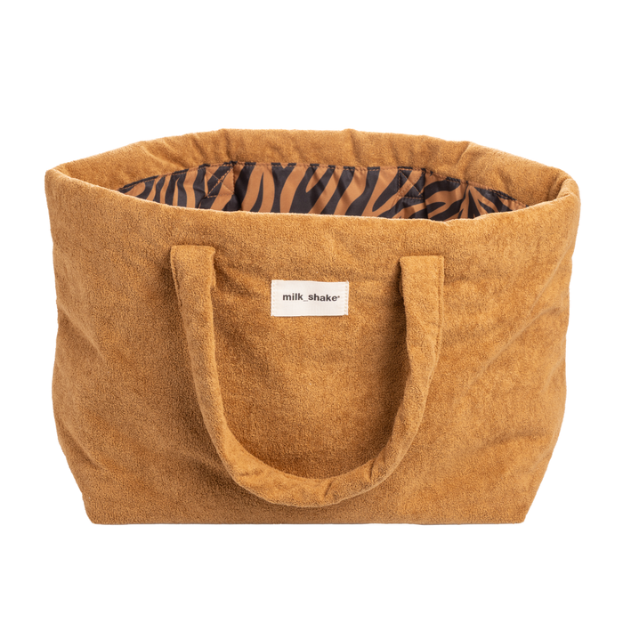 Brown tote bag with a zebra pattern interior and 'milk shake' label on a white background
