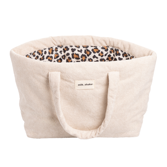 Beige beach bag with leopard print interior and 'milk_shake' label on a white background