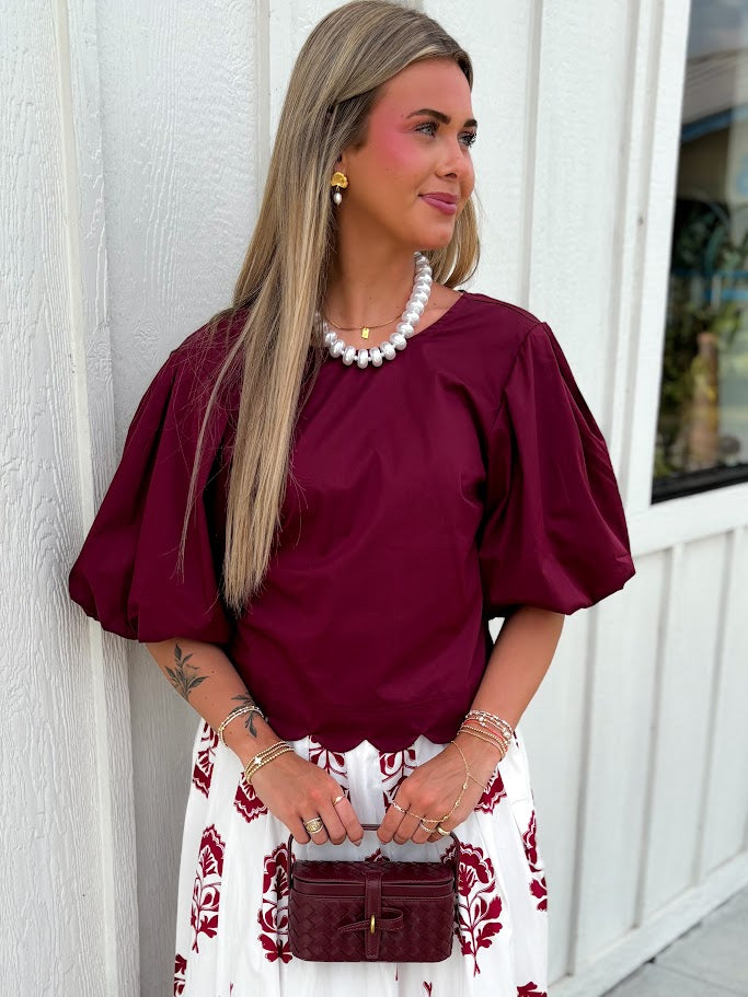 short sleeve maroon shirt with scallop bottom