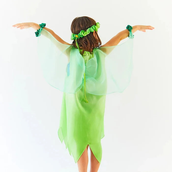 Child wearing green dress with wings