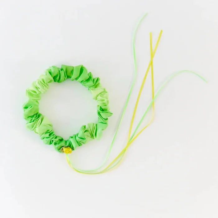 Green silk garland with yellow rose and ribbons on a white background