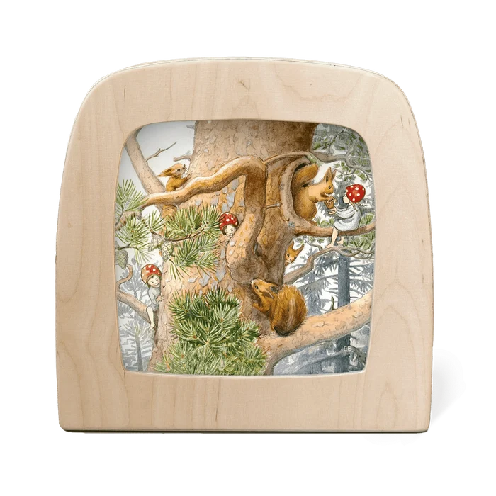 Wooden frame with silhouette of children and squirrels playing in a tree on a white background