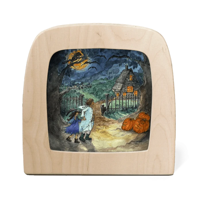 Wooden frame with silhouette of two children trick or treating in the woods