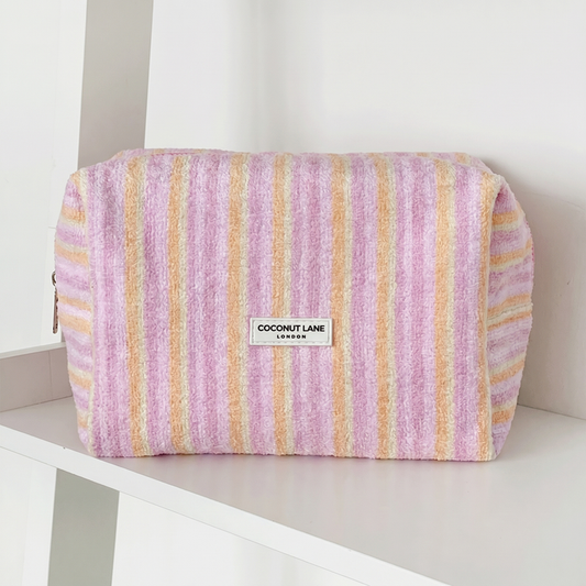 Pink, orange and yellow striped Makeup Bag in towel fabric with Coconut Lane logo.