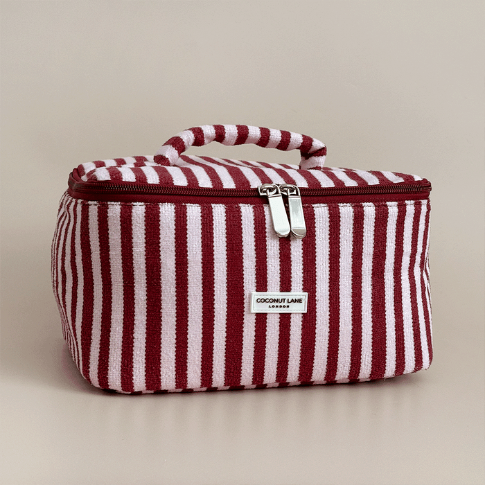 Burgundy and light pink striped Vanity Case, with handle, silver zip and Coconut Lane logo badge.
