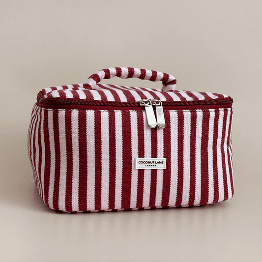 Burgundy and light pink striped Vanity Case, with handle, silver zip and Coconut Lane logo badge.