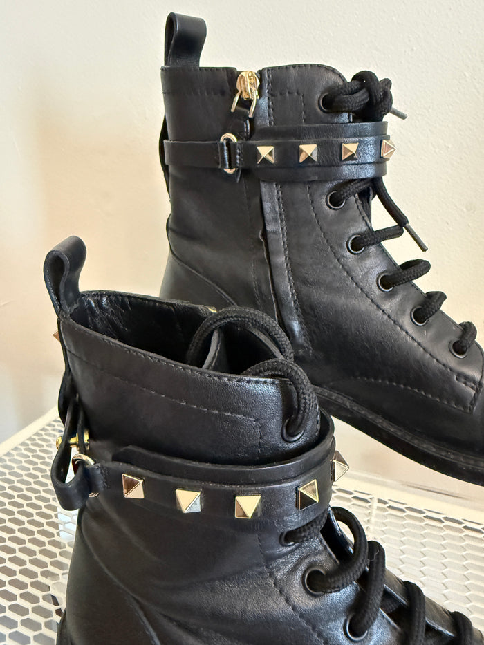 Valentino Rock Stud Combat Boots in size 38.5, featuring black leather and signature stud embellishments with rugged lace-up design.