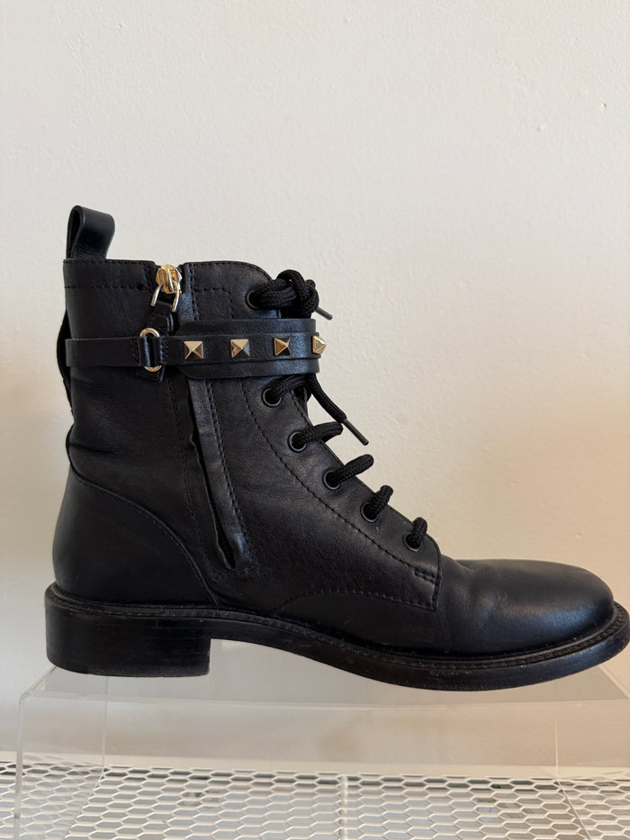 Valentino Rock Stud combat boots in size 38.5, featuring black leather and signature stud details, shown from the front.