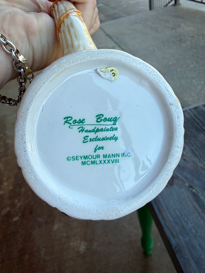 Close-up of a ceramic product with branding text on a blurred background