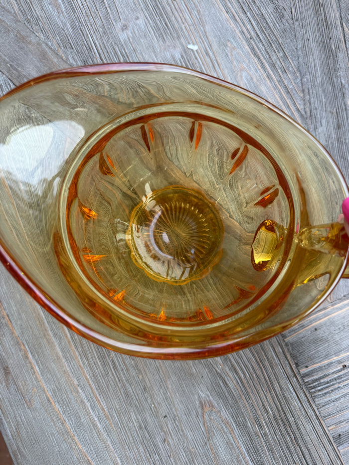 Clear glass with gold interior on a wooden surface