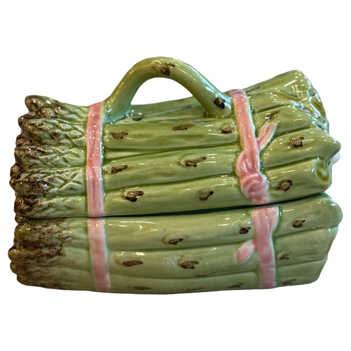 Ceramic log-shaped object with a handle on a white background