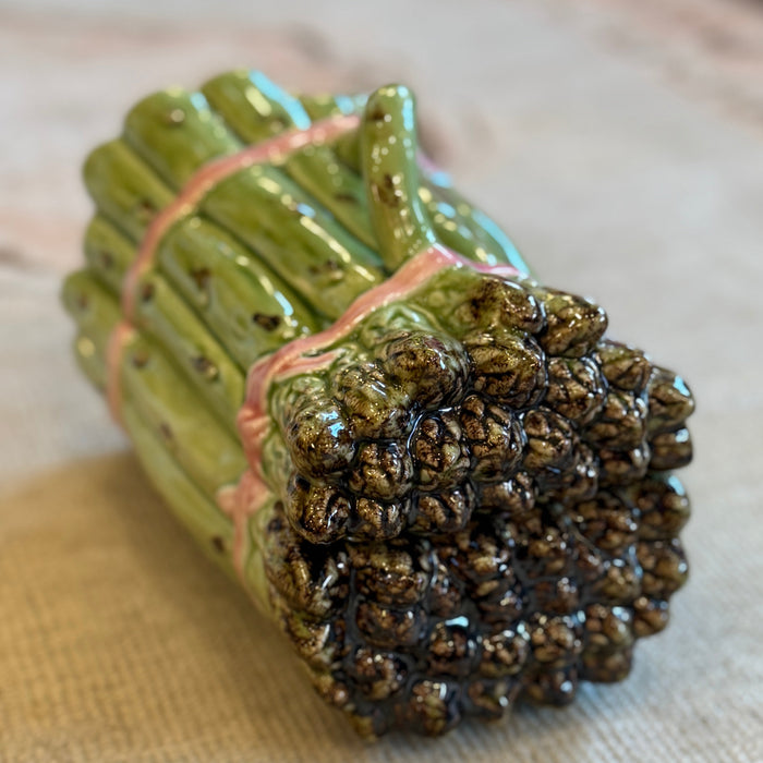 Ceramic bundle of sticks with textured ends on a patterned fabric background