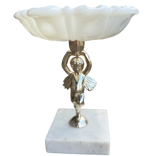 Decorative lamp with a cherub figure on a marble base against a white background