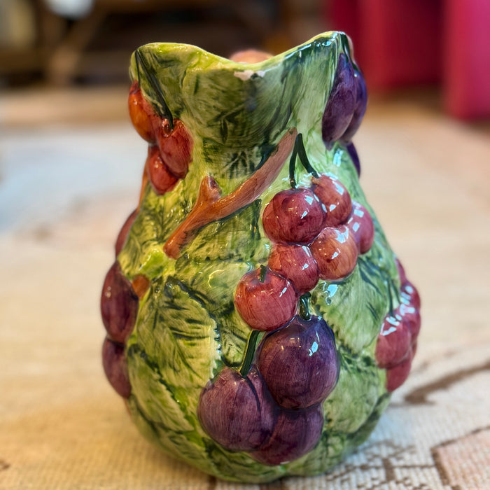 Decorative owl figurine with grape design on a table
