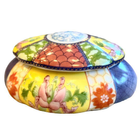 Decorative ceramic jar with colorful design on a white background