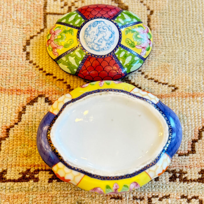 Decorative ceramic dish with colorful patterns on a textured surface