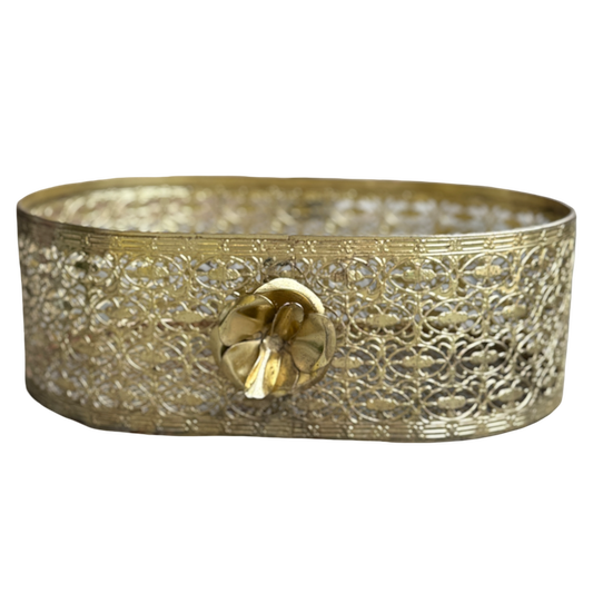 Decorative brass tray with intricate patterns on a white background