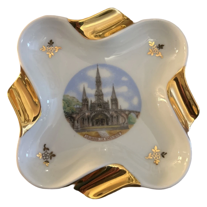 Decorative ceramic dish with gold accents and a central design of a cathedral.