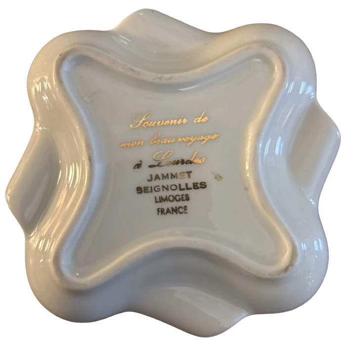 White ceramic dish with gold and black text on a white background