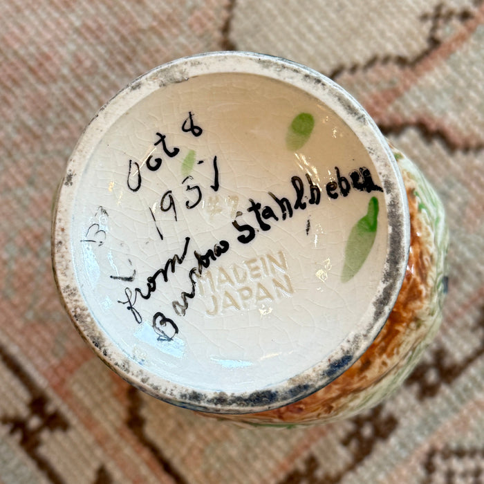 Close-up of a ceramic product with a label on a textured surface