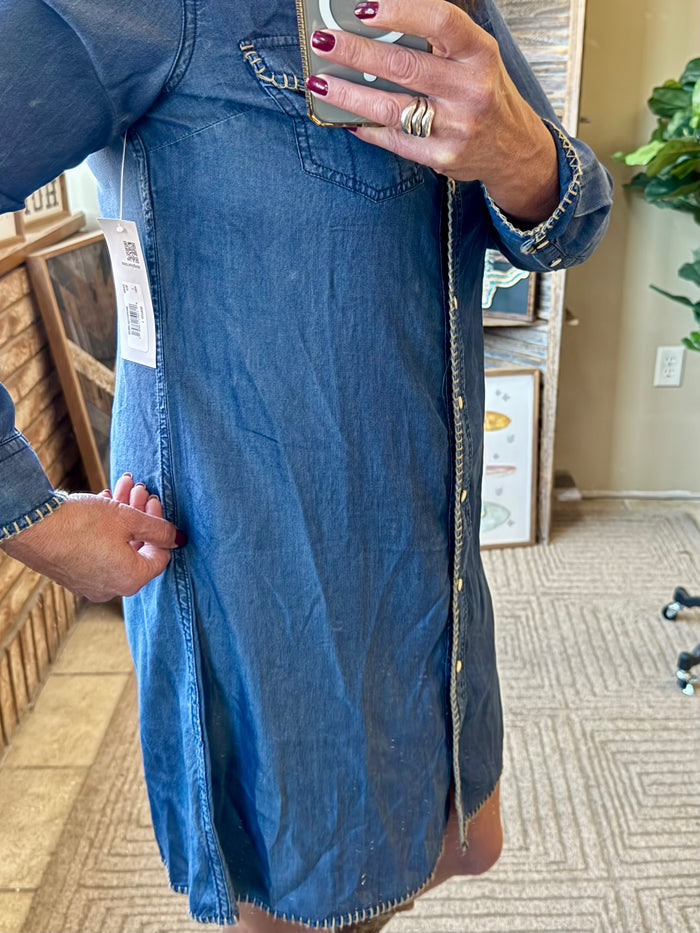 Blue denim snap-front dress close-up with front placket and whip stitching