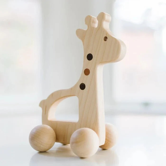 Wooden push toy giraffe on a white background
